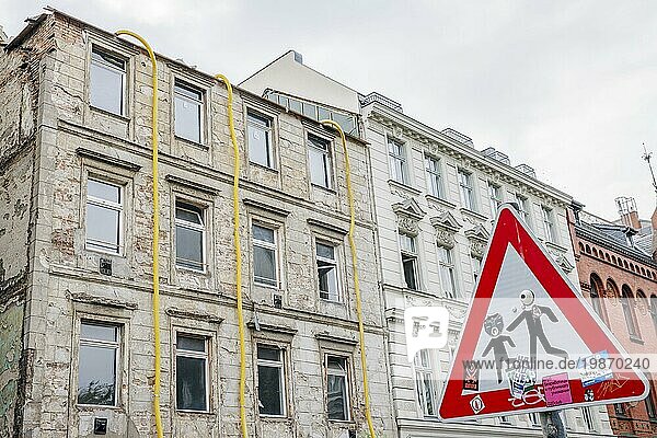 Symbolic photo on the subject of renovating old buildings. A residential building in need of renovation in Berlin Mitte stands next to an already renovated house. Berlin  06.10.2023