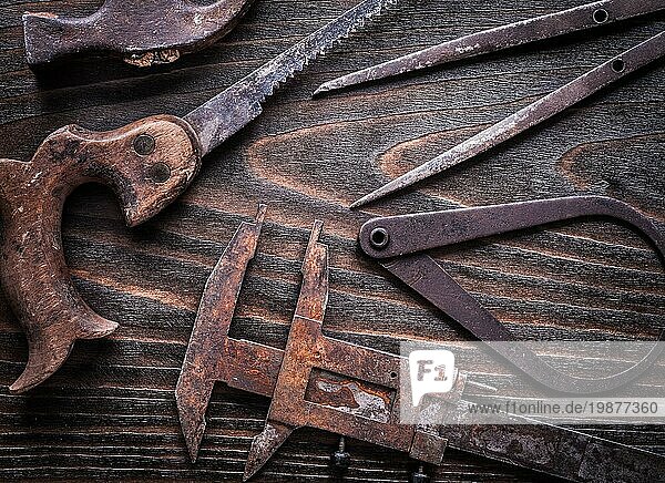 Rusted vintage calipers Handsäge und Klauenhammer auf Vintage Holzbrett Baukonzept