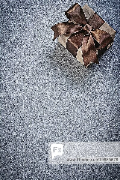Geschenkbox mit gebundenen braunen Knoten auf grauem Hintergrund Feiern Konzept