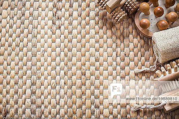 Copy space image of brush wooden massagers and loofah on wicker mat healthcare concept