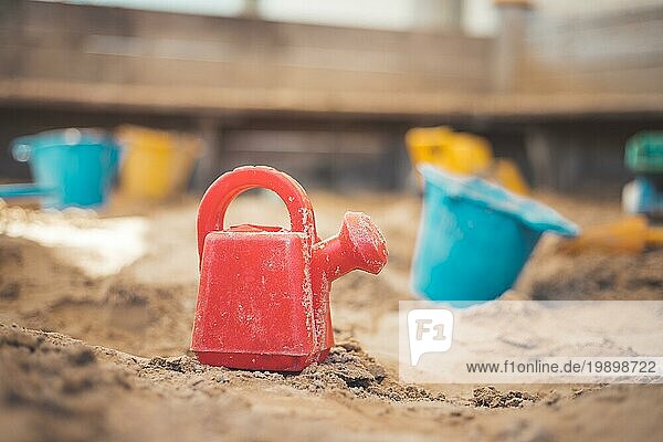 Kinder Plastikspielzeug im Sandkasten. Gießkanne  selektiver Fokus