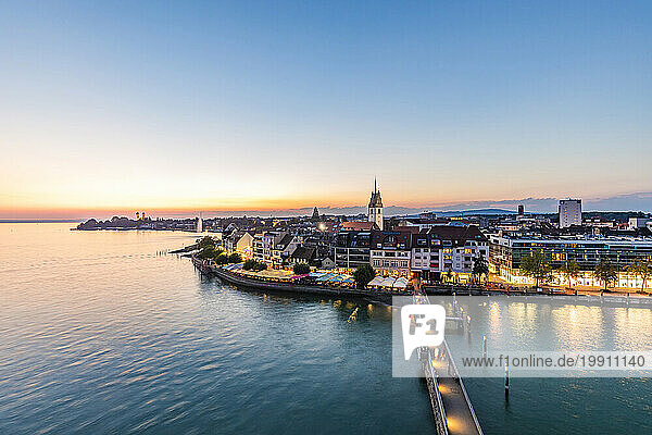 Germany  Baden-Wurttemberg  Friedrichshafen  Waterfront of city on shore of lake Bodensee at dawn