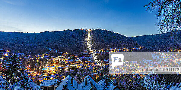 Germany  Baden-Wurttemberg  Bad Wildbad  Illuminated town in Black Forest range at winter dusk