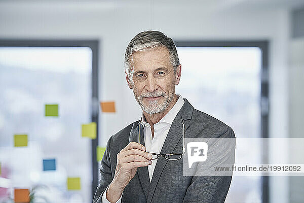 Smiling businessman with eyeglasses in office