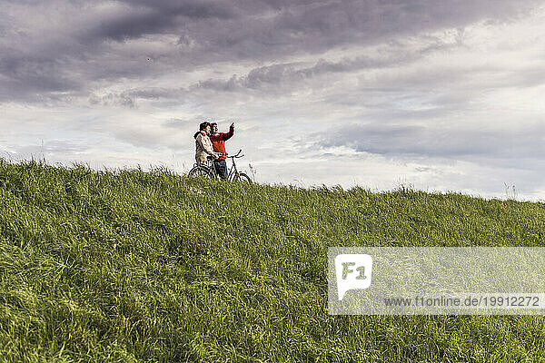 Senior couple looking at view under cloudy sky