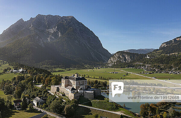 Austria  Styria  Stainach-Purgg  Drone view of Trautenfels Castle and Grimming peak