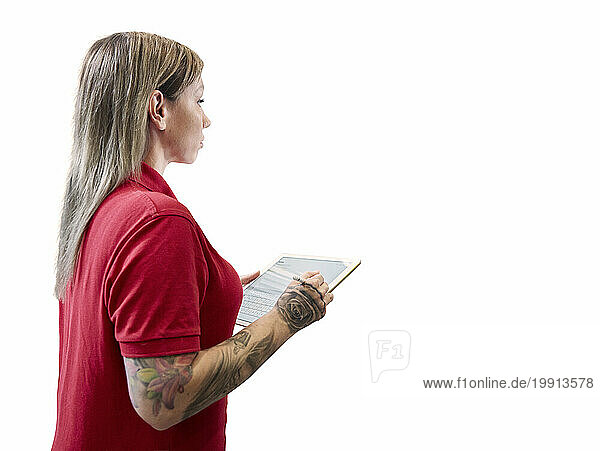 Technician with tablet PC standing against white background