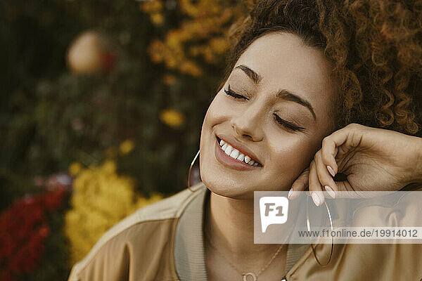 Smiling woman with eyes closed