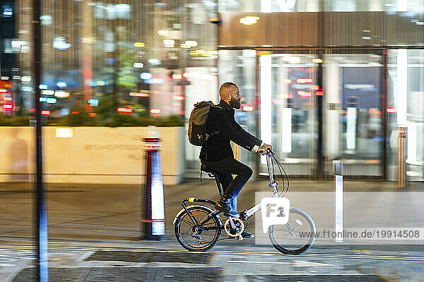 Man commuting through cycle on street in city