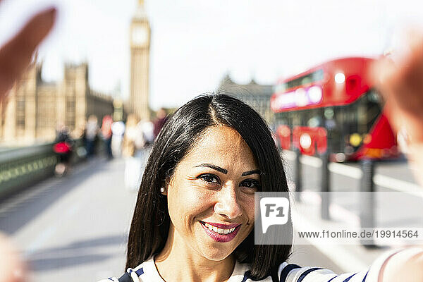 Smiling woman taking selfie in London city