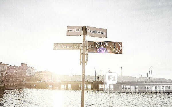 Street direction sign by river  Stockholm  Sweden