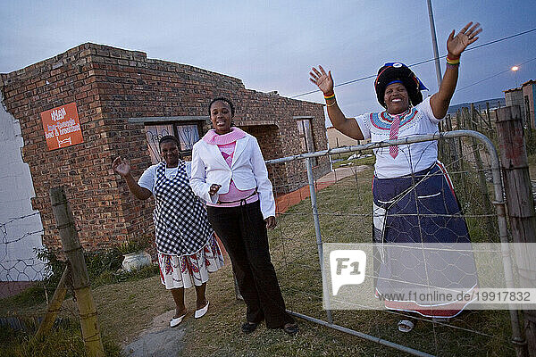 The owner of a township bed and breakfast waves goodbye to a visiting tourist in Joza Township  Grahamstown  South Africa.