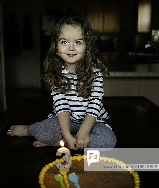 Happy little girl smiling with birthday cake