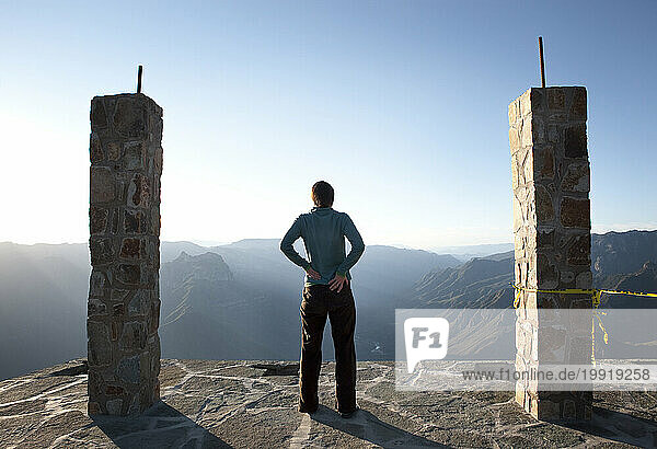 A runner stretches and looks out over the Copper Canyon  Mexico.