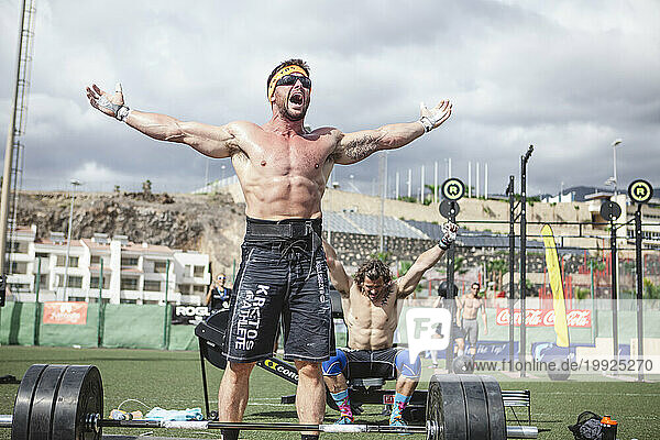 Weightlifting team athletes shouting with joy after winning competition  Tenerife  Canary Islands  Spain