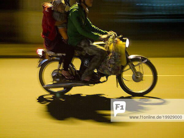 Scooter travelers at night in Hoi An  Vietnam
