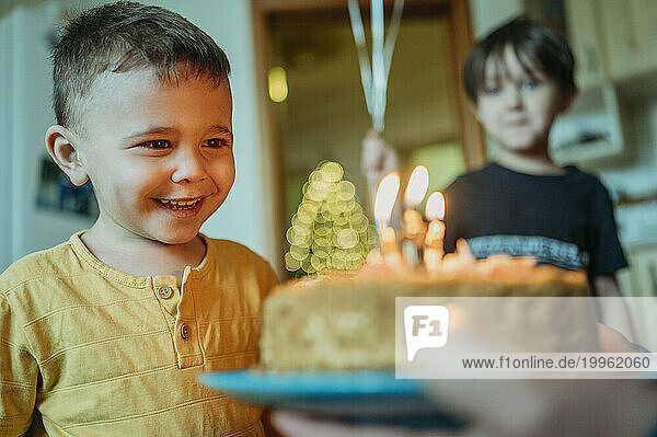 Excited boy looking at birthday cake