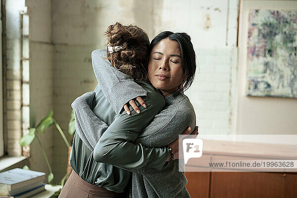 Women hugging each other at art studio
