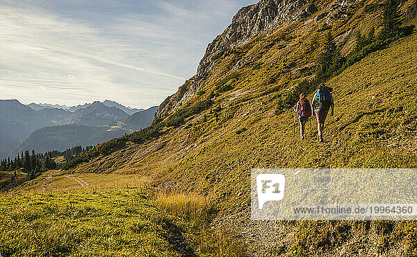 Man and woman hiking in Tannheimer Tal  Tyrol  Austria