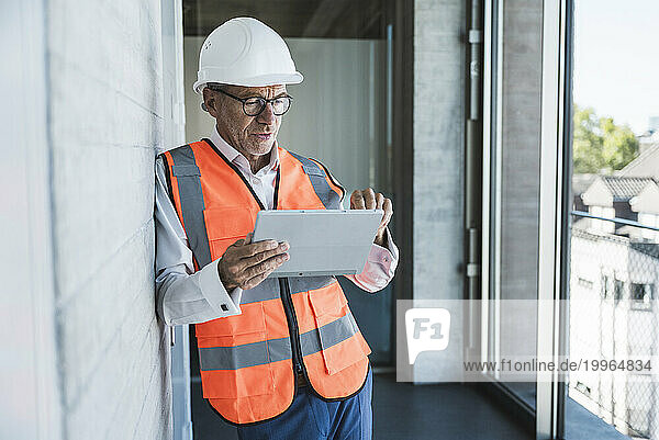 Engineer using tablet PC in corridor