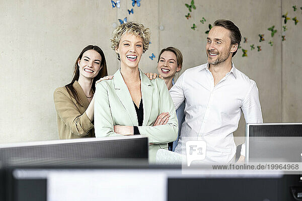 Cheerful business colleagues standing in office
