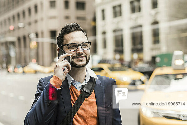 Smiling businessman talking on smart phone