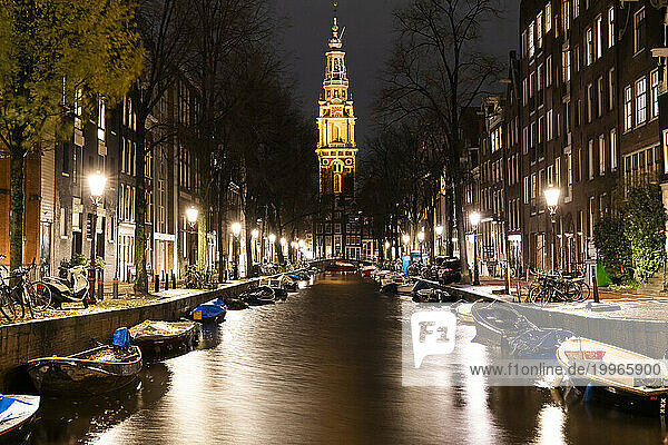 Boats moored along canal near Zuiderkerk church at Amsterdam  Netherlands