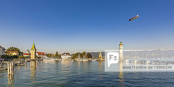 Germany  Bavaria  Lindau  Marina of town on shore of lake Bodensee with blimp flying in background