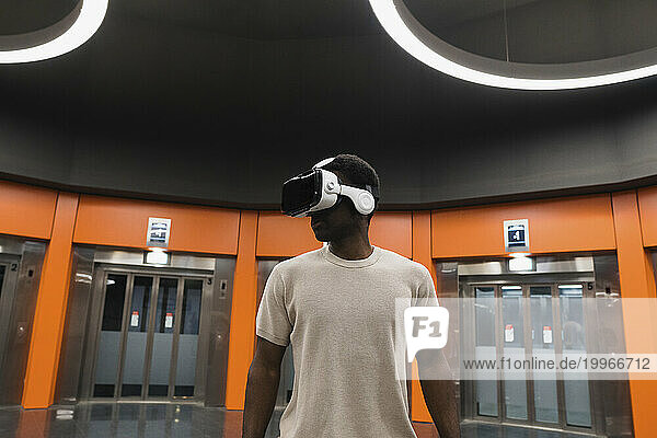 Young man using Virtual Reality Simulator at Metro Station
