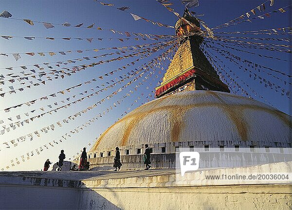 Worshippers parade around the Great Stupa in the Tibetan quarter at Boddnath or Bauda in the Kathandu valley  Nepal  Asia