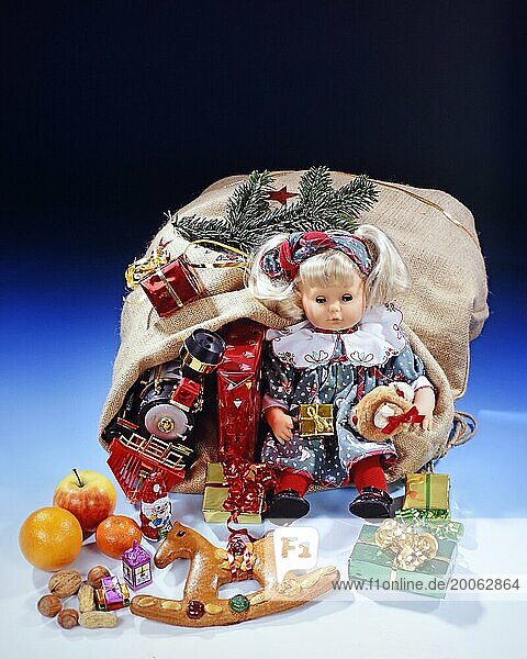 Weihnachtsgeschenke  Studioaufnahme  Geschenke im Sack  Weihnachtsmann  Nüsse  Früchte  Teddybär  Puppe  Eisenbahn