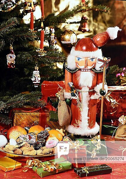 Ein attraktiver Nussknacker vor weihnachtlicher Dekoration  Weihnachtsbaum im Hintergrund