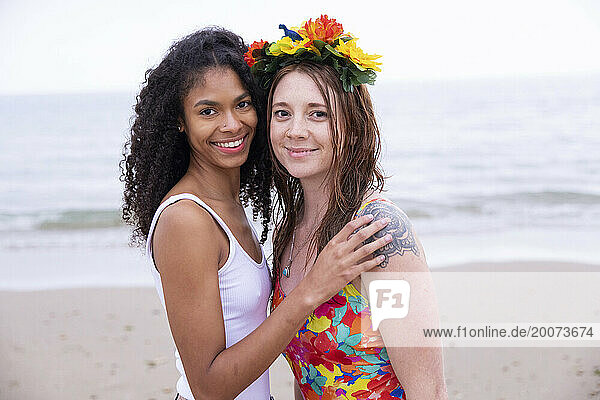 portraits of young mixed race women  friends posing on the beach having fun.