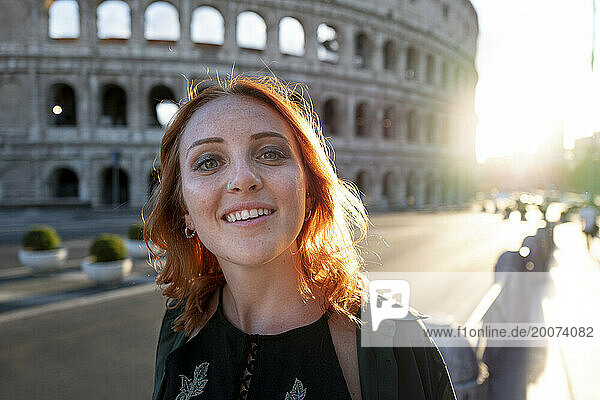Young woman with red hair  near Colluseum  Rome  Italy
