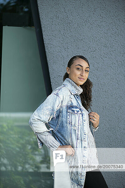 Mixed race attractive woman portrait against a grey wall for work