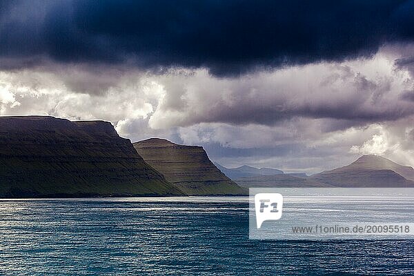 Coastal line of the Faroe Islands with an overcast and dramatic sky