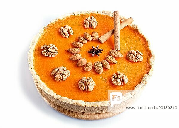 Traditional american sweet pumpkin pie decorated with nuts  isolated on white background. close up