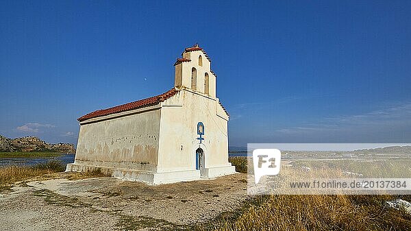 Agiou Petrou Chapel  Chapel of St Peter  Small church stands isolated under a clear blue sky next to a body of water  Strofilia biotope  wetlands  Kalogria  Peloponnese  Greece  Europe