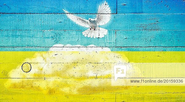 Friedenstaube auf einer Betonwand in den Farben der Ukrainenfahne