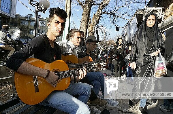Young Iranian street musicians with guitars in Arak  Iran  woman with chador on 16 March 2019. After the withdrawal of the USA from the international nuclear agreement  the country is again imposing sanctions against Iran  Asia