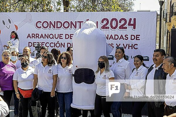 Oaxaca  Mexico  Health workers pose for photos with a person wearing a condom costume as part of their campaign against sexually-transmitted diseases. Afterwards  they walked the streets  handing out free condoms  Central America