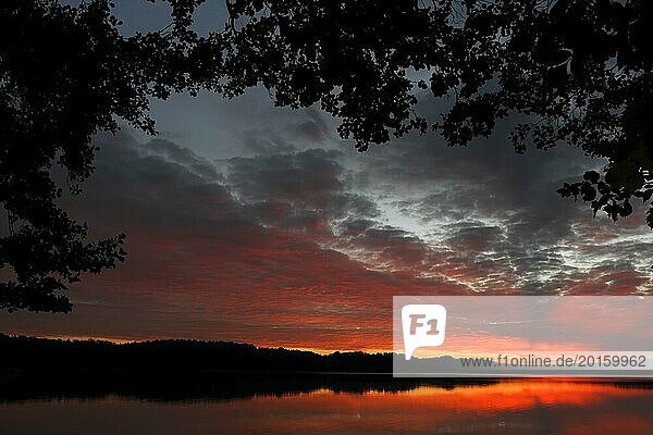 Sunrise with cloud formation over a lake in Mecklenburg  Müritz National Park  Mecklenburg-Vorpommern  Germany  Europe