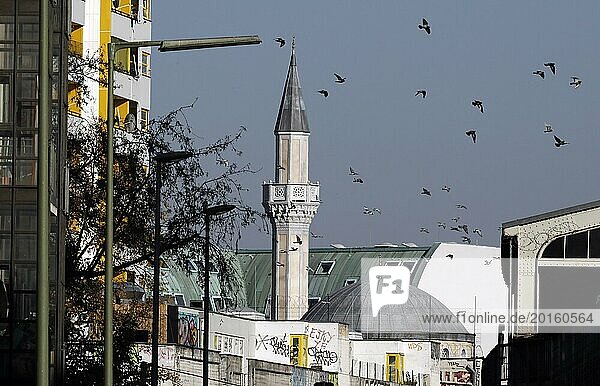 Pigeons fly at the minaret of the Mevlana mosque in Berlin's Kreuzberg district  12 October 2018