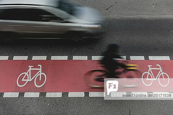 Ein Radfahrer fährt auf einem markierten Radweg auf der Schlossstraße und wird von einem Auto überholt in Berlin  27.02.2024