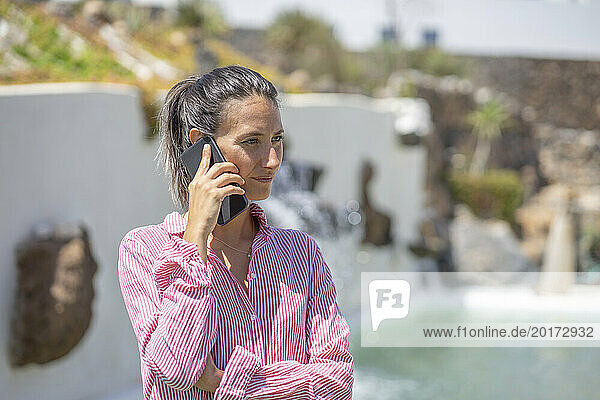 Woman talking on smart phone at resort