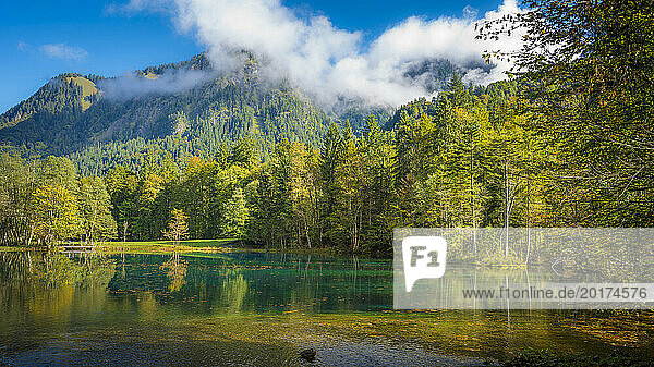Germany  Bavaria  Oberstdorf  Scenic view of Christlessee lake with forested mountain in background