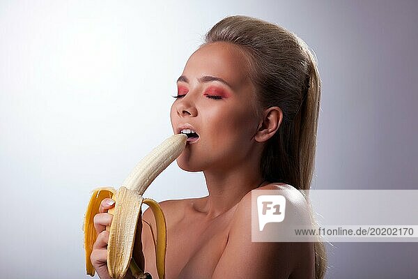 Hübsches junges Mädchen essen sexy lange Banane mit Lust