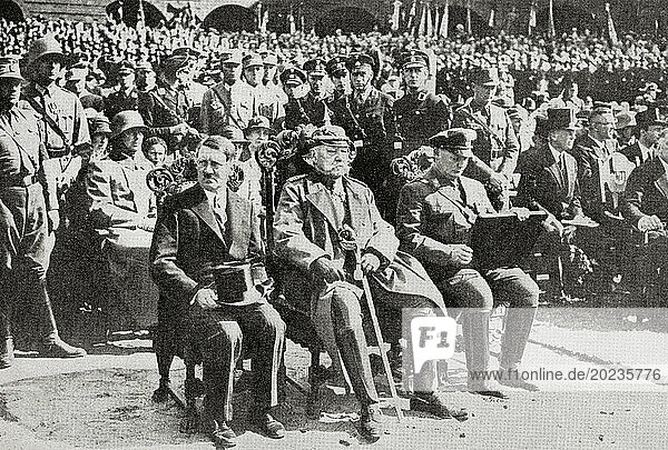 From left to right  Adolf Hitler  1889 – 1945. German politician  demagogue  Pan-German revolutionary  leader of the Nazi Party  Chancellor of Germany  and Führer of Nazi Germany from 1934 to 1945. Paul Ludwig Hans Anton von Beneckendorff und von Hindenburg  1847 – 1934. German field marshal  statesman and President of Germany  and Hermann Wilhelm Göring or Goering  1893 – 1946. German politician  military leader  and convicted war criminal. Seen here in 1933 when Hitler had just been appointed the new chancellor of Germany. From The War in Pictures  First Year.