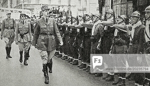 EDITORIAL General de Gaulle reviewing a unit of his force  14 July 1940. Charles André Joseph Marie de Gaulle  1890 – 1970. French military officer  statesman and 18th President of France. From The War in Pictures  First Year.