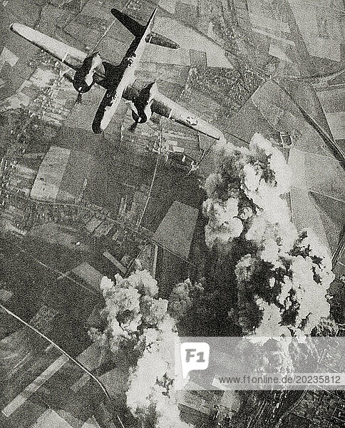 British R.A.F. planes dropping high-explosive bombs on a Nazi rail centre during WWII. From The War in Pictures  Fifth Year.